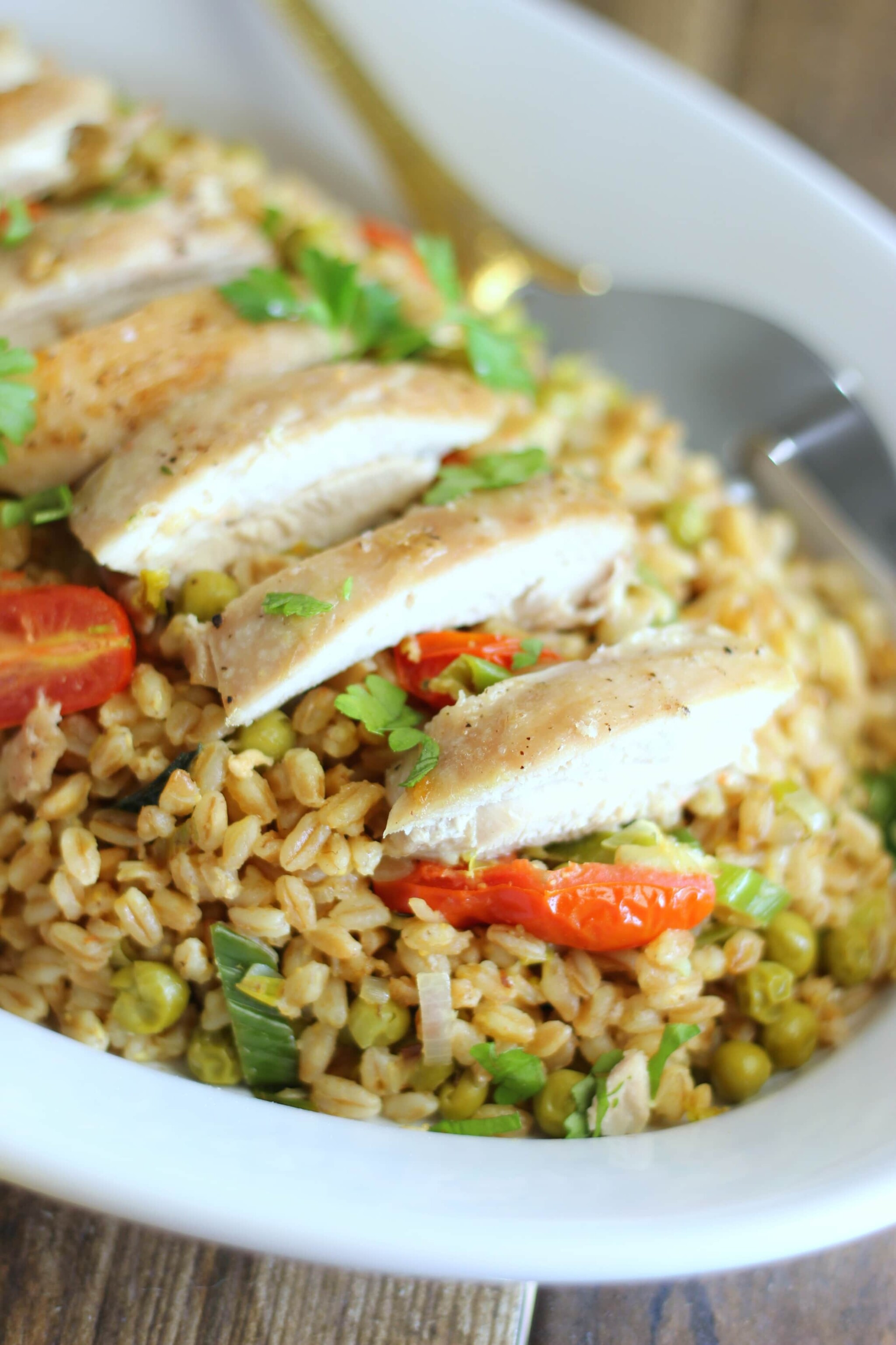 This roasted chicken with farro and fresh spring veggies is a delightful and complete dinner recipe that you can easily prepare for a week night meal.